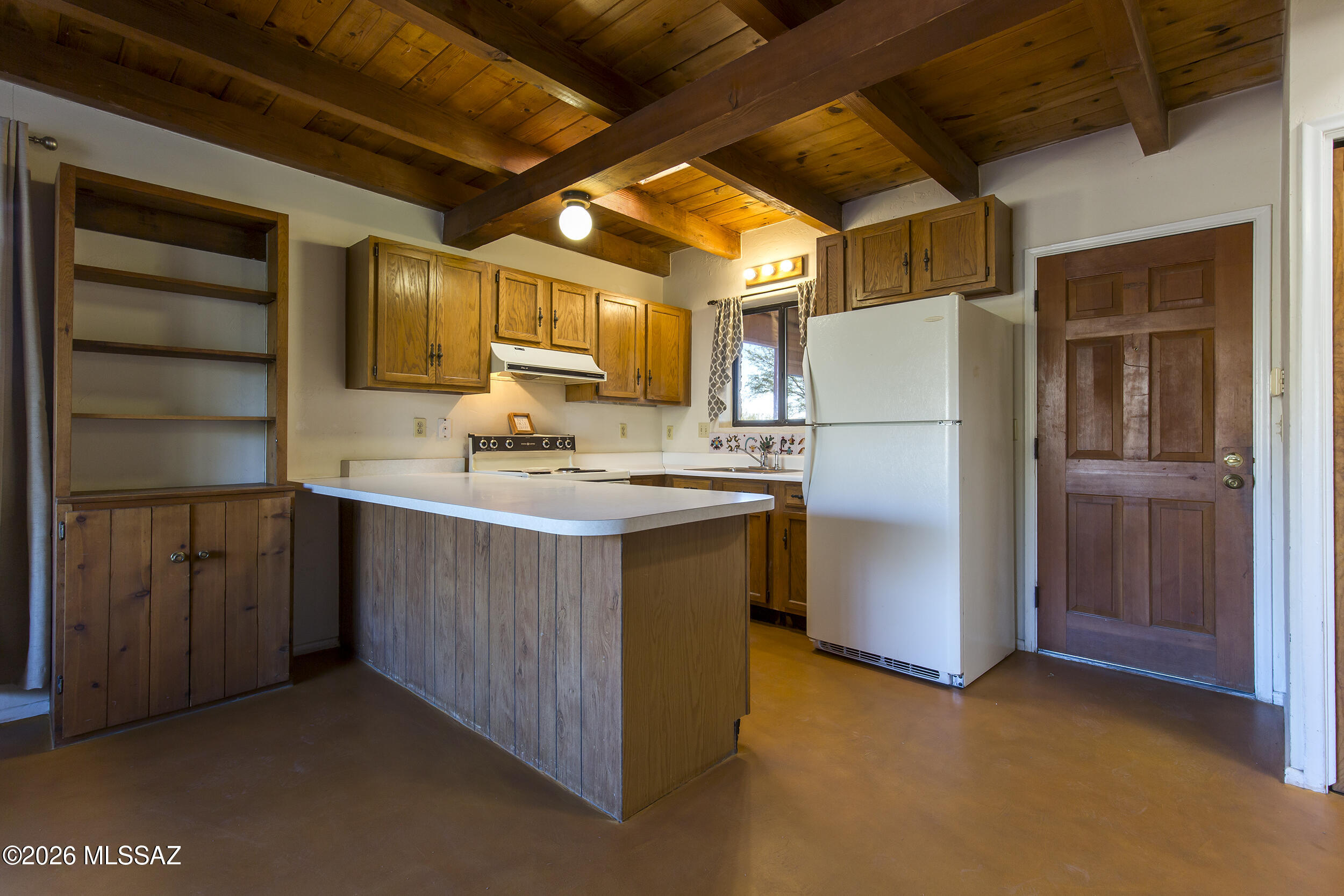 4130 East River Road Tucson, AZ 85718 - Photo 34 of 46 a kitchen with a refrigerator sink and cabinets