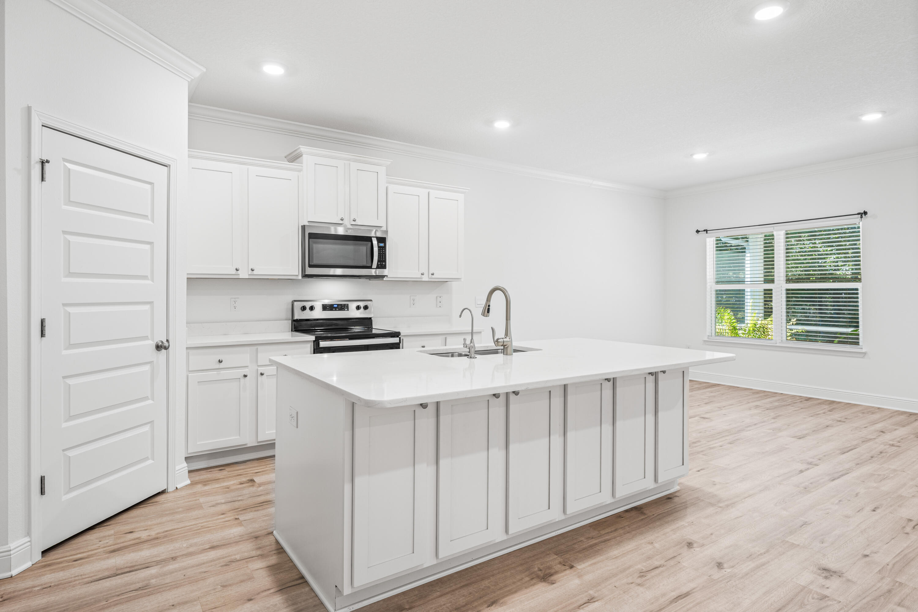 157 Jr's Way Santa Rosa Beach, FL 32459 - Photo 11 of 45 a kitchen with a sink cabinets and wooden floor
