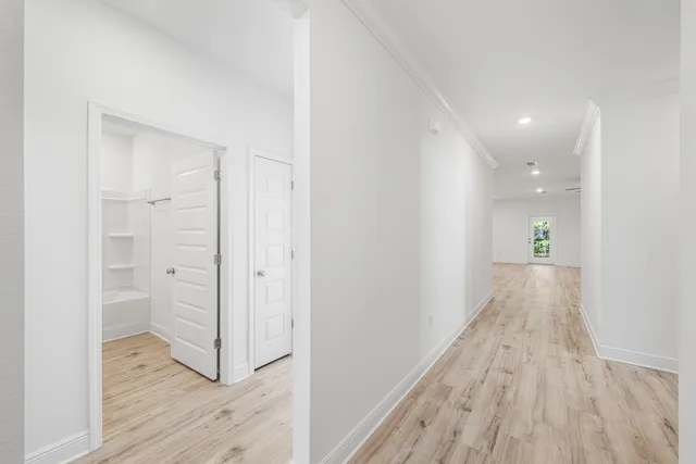 a view of a hallway view with wooden floor and staircase