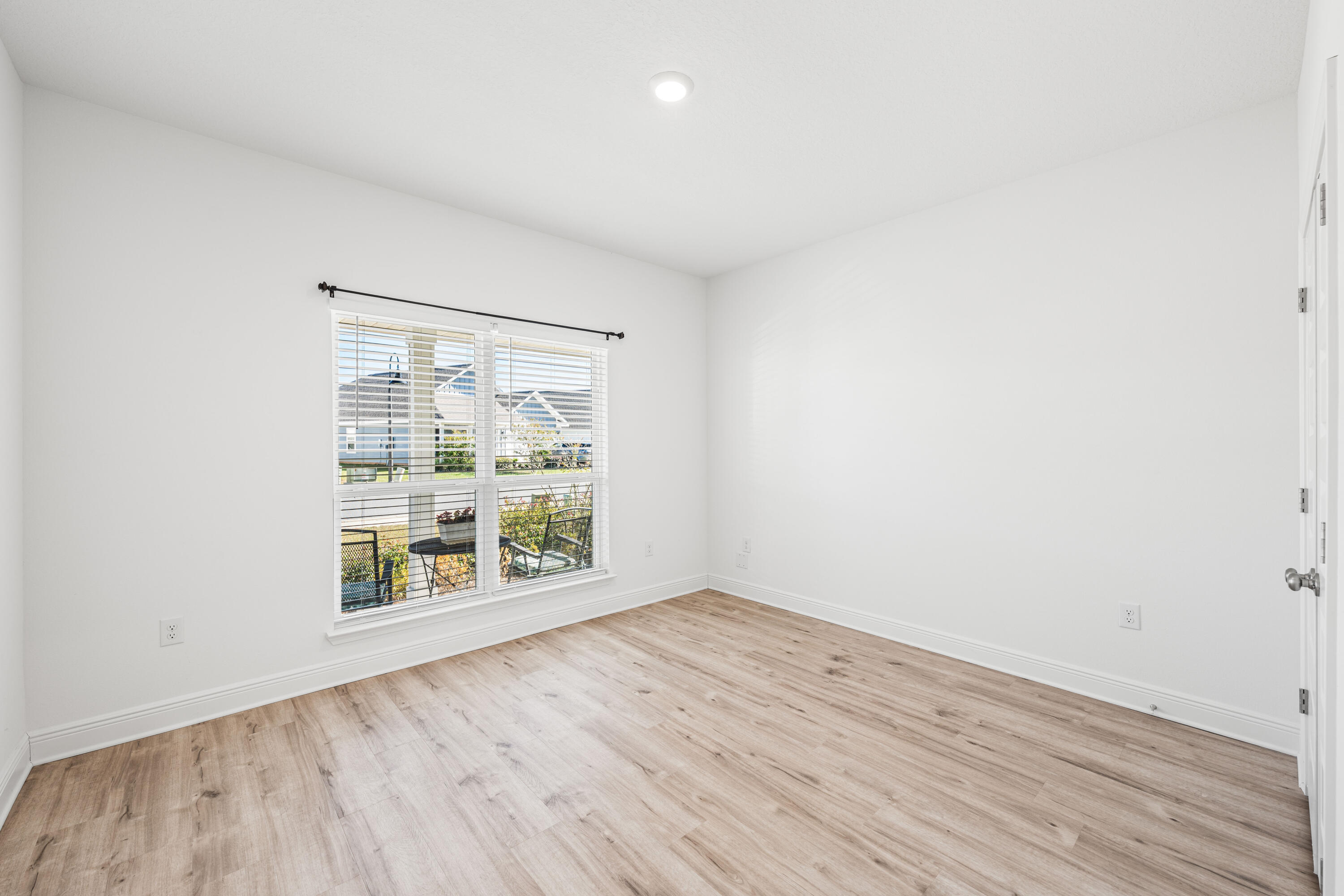 157 Jr's Way Santa Rosa Beach, FL 32459 - Photo 18 of 45 an empty room with wooden floor and windows
