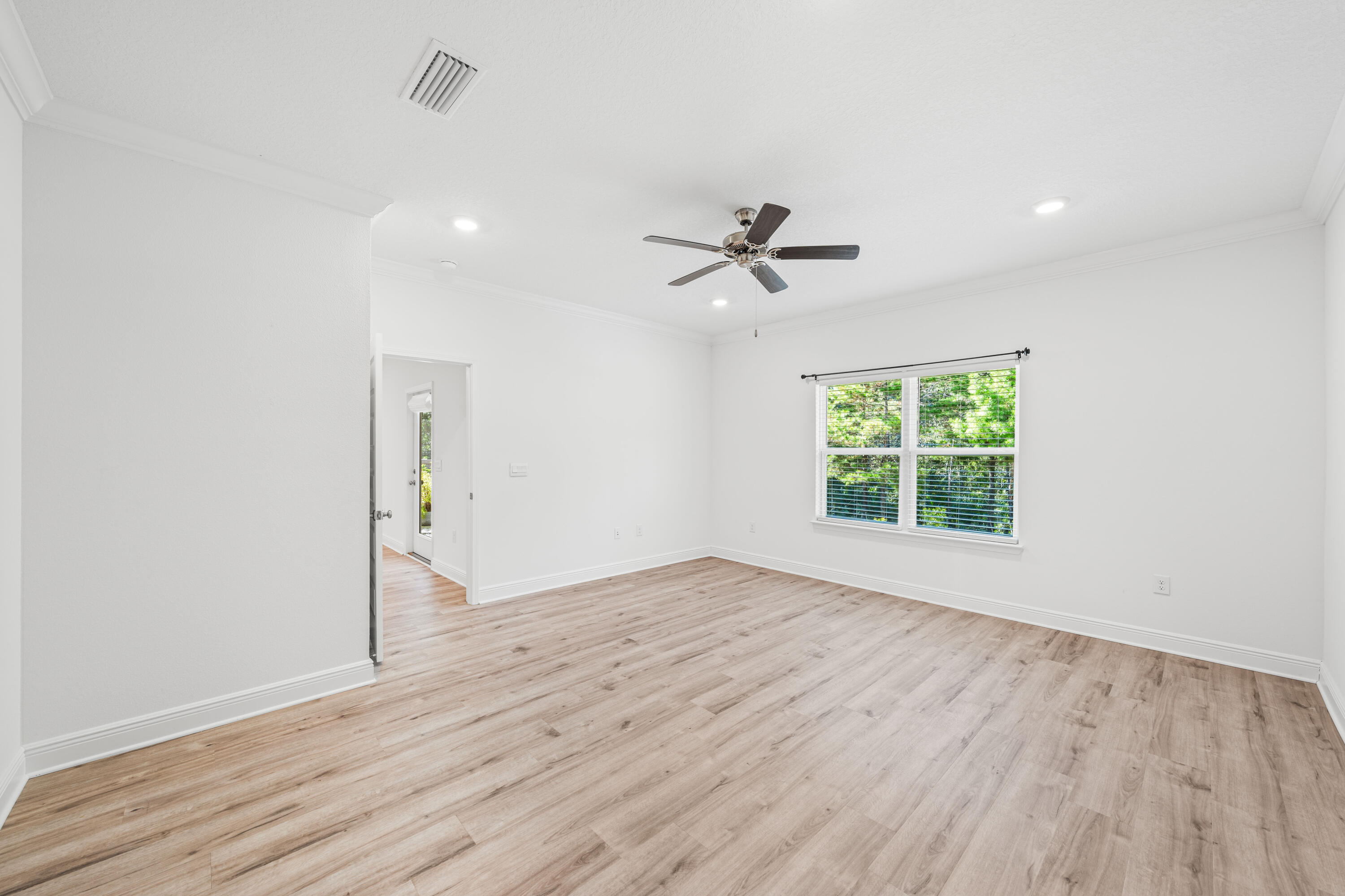 157 Jr's Way Santa Rosa Beach, FL 32459 - Photo 29 of 45 an empty room with wooden floor and windows