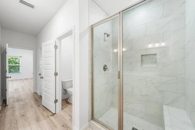 a bathroom with a glass shower door and a bathtub