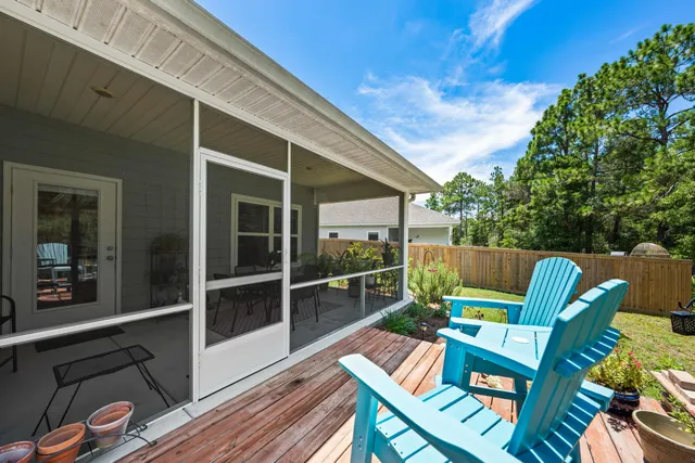 a view of a patio with table and chairs and wooden floor