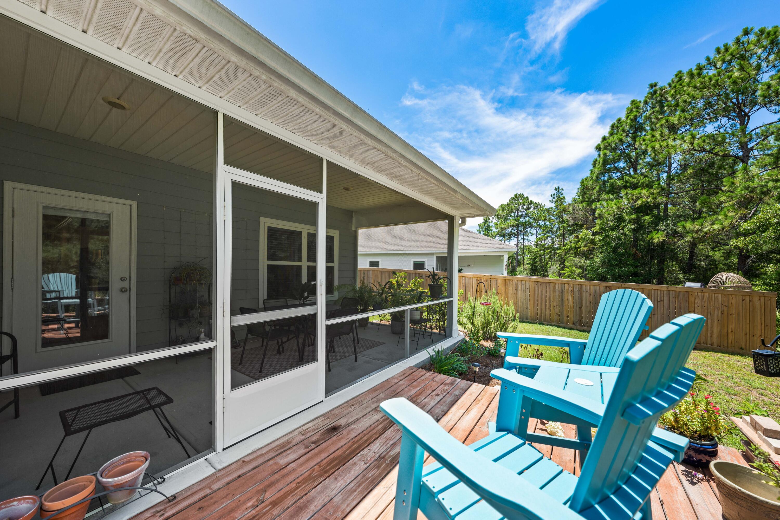 157 Jr's Way Santa Rosa Beach, FL 32459 - Photo 36 of 45 a view of a patio with table and chairs and wooden floor