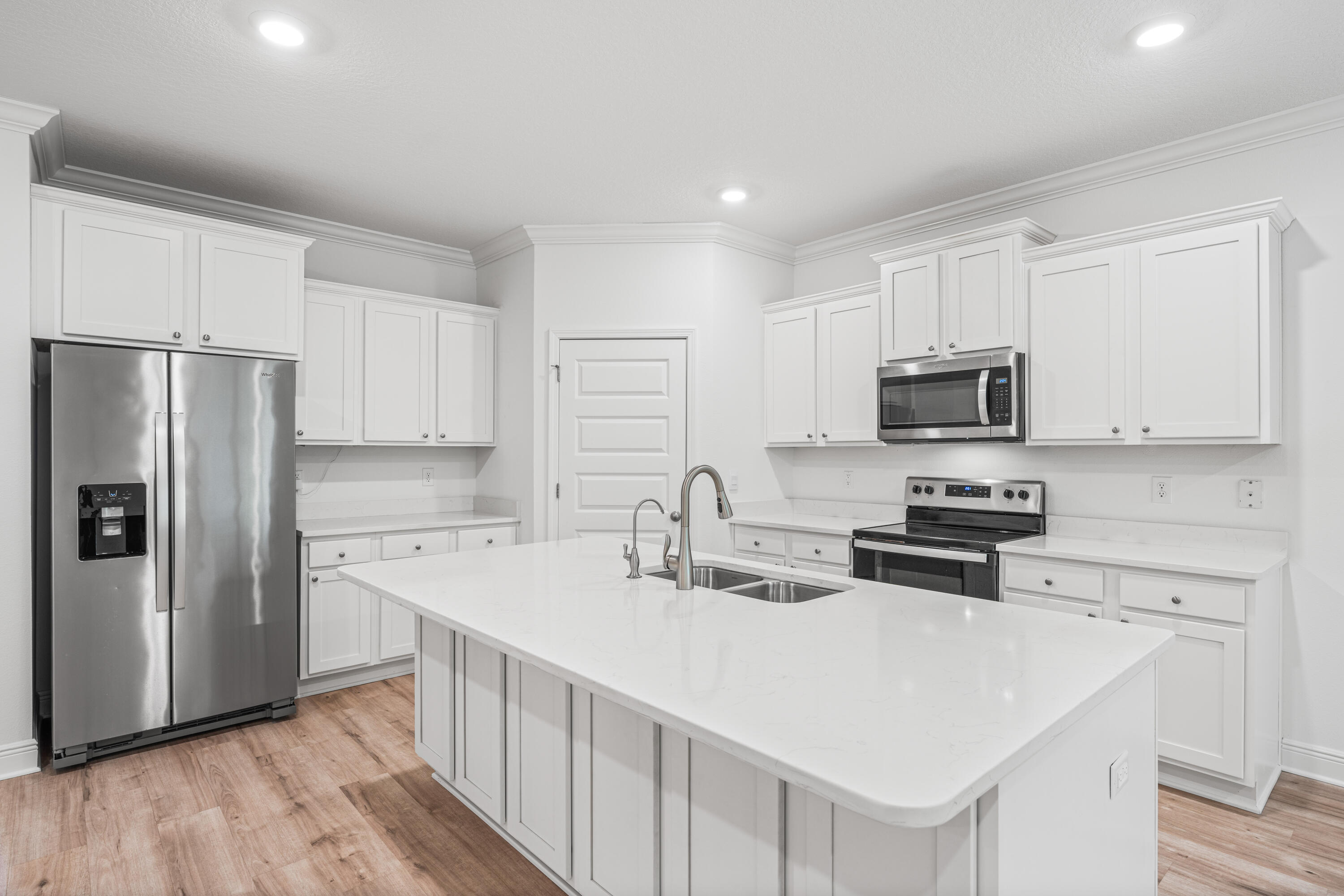 157 Jr's Way Santa Rosa Beach, FL 32459 - Photo 8 of 45 a kitchen with stainless steel appliances a sink a stove a refrigerator cabinets and a counter space