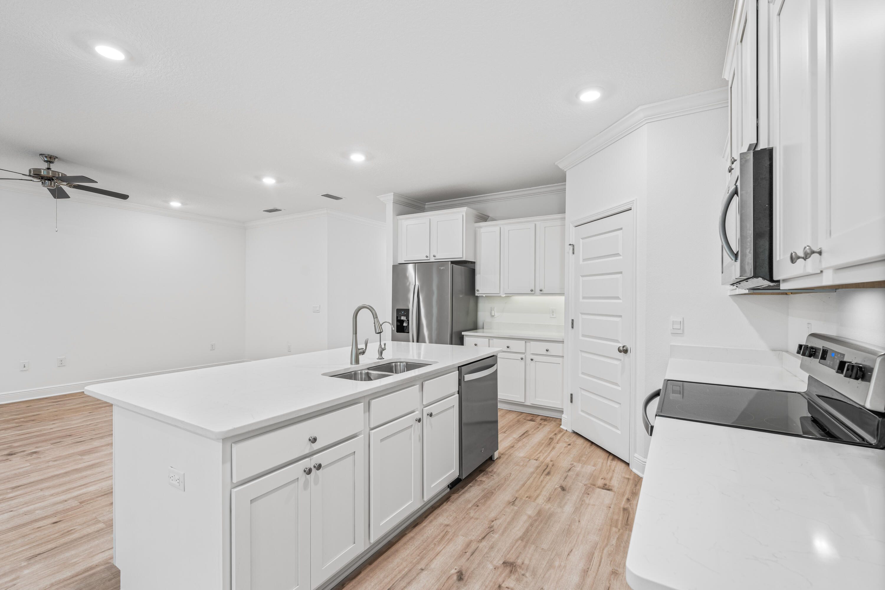 157 Jr's Way Santa Rosa Beach, FL 32459 - Photo 9 of 45 a kitchen with white cabinets sink and stainless steel appliances