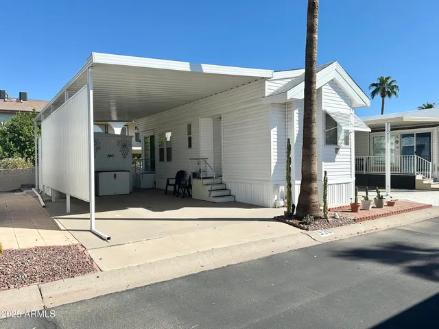 a backyard of a house with table and chairs