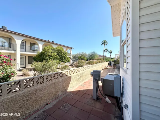 a living room with furniture a flat screen tv and kitchen view