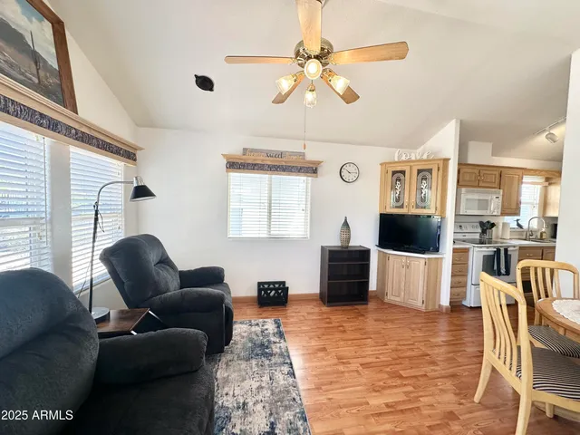 a living room with furniture a chandelier and a fireplace