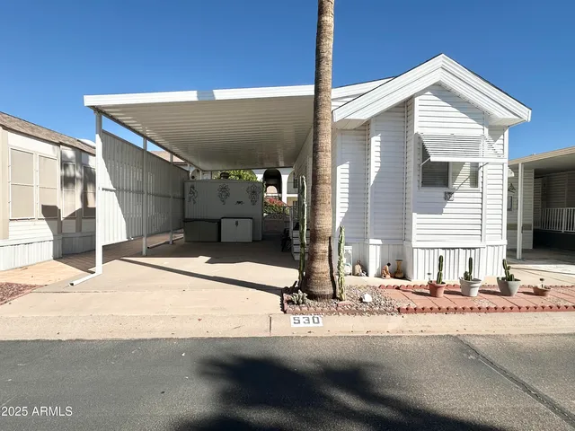 a view of a patio with furniture and refrigerator