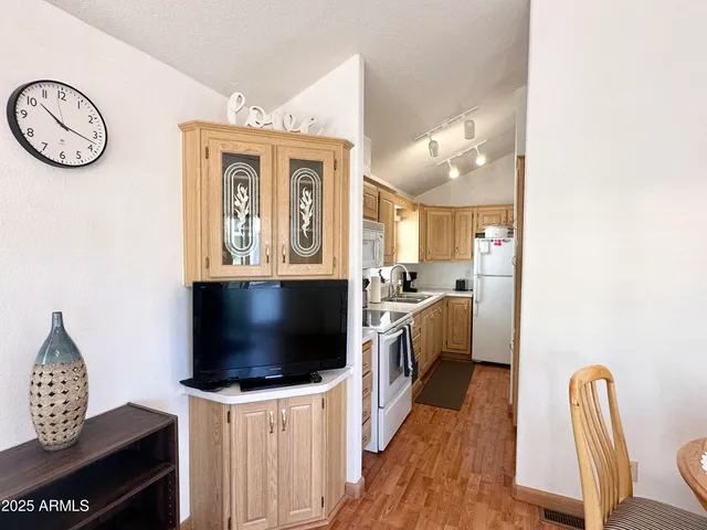 a kitchen with a refrigerator a stove top oven and a sink