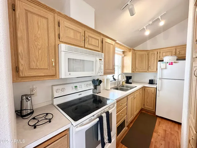 a kitchen with a refrigerator a sink and cabinets