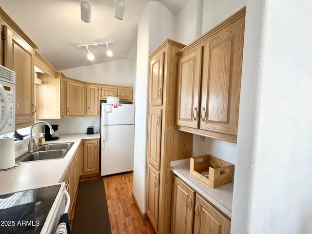 a white refrigerator freezer sitting in a kitchen