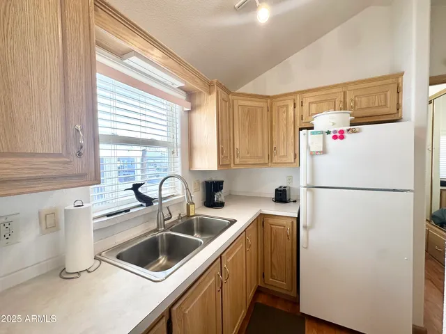 a white refrigerator freezer sitting inside of a kitchen