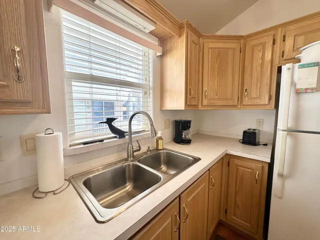 a living room with furniture a flat screen tv and a window