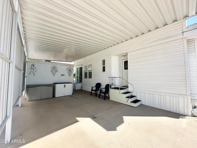 a view of a patio with table and chairs and wooden floor
