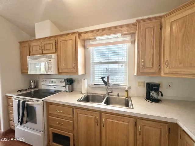 a kitchen that has a sink and a stove
