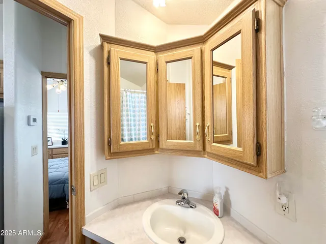 a bathroom with a tub sink and a mirror