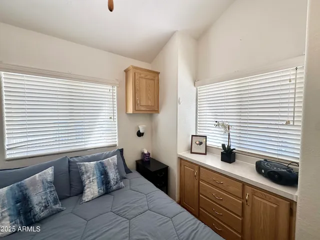 a spacious bedroom with a large bed and a chandelier