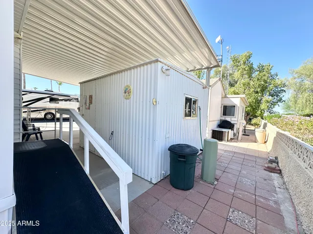 a view of a patio with chairs and potted plants