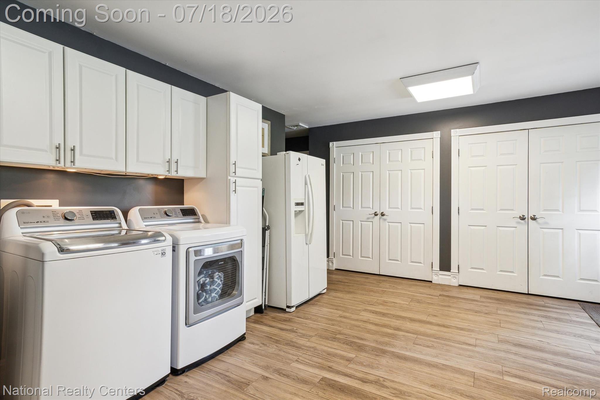 9589 Clinton Macon Road Tecumseh, MI 49286 - Photo 21 of 48 Dedicated utility space featuring wood-finish flooring and multiple storage options