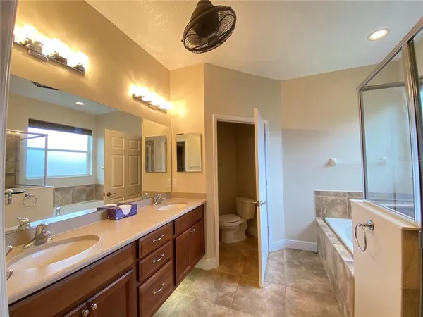 a spacious bathroom with a double vanity sink a mirror and shower