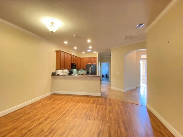 a view of kitchen with kitchen island and wooden floor
