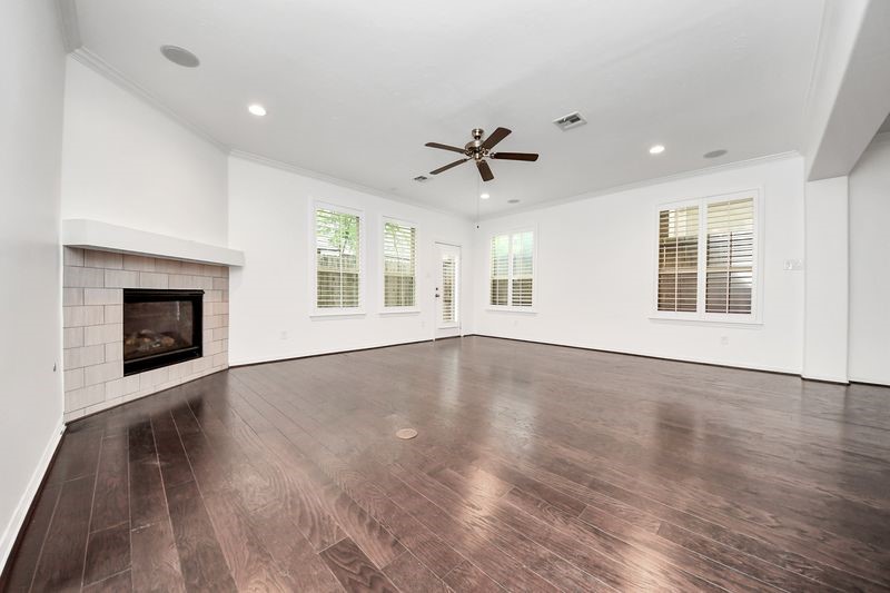 4222 Drake Street Houston, TX 77005 - Photo 7 of 28 a view of an empty room with wooden floor and a window