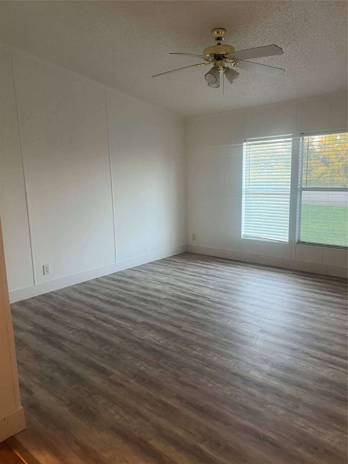 10312 Farm To Market Road 457 Bay City, TX 77414 - Photo 13 of 16 wooden floor in an empty room with a window