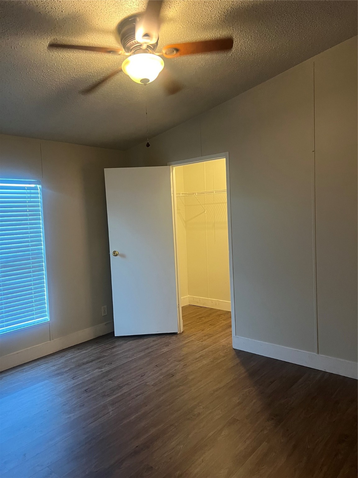 10312 Farm To Market Road 457 Bay City, TX 77414 - Photo 4 of 16 an empty room with wooden floor and windows