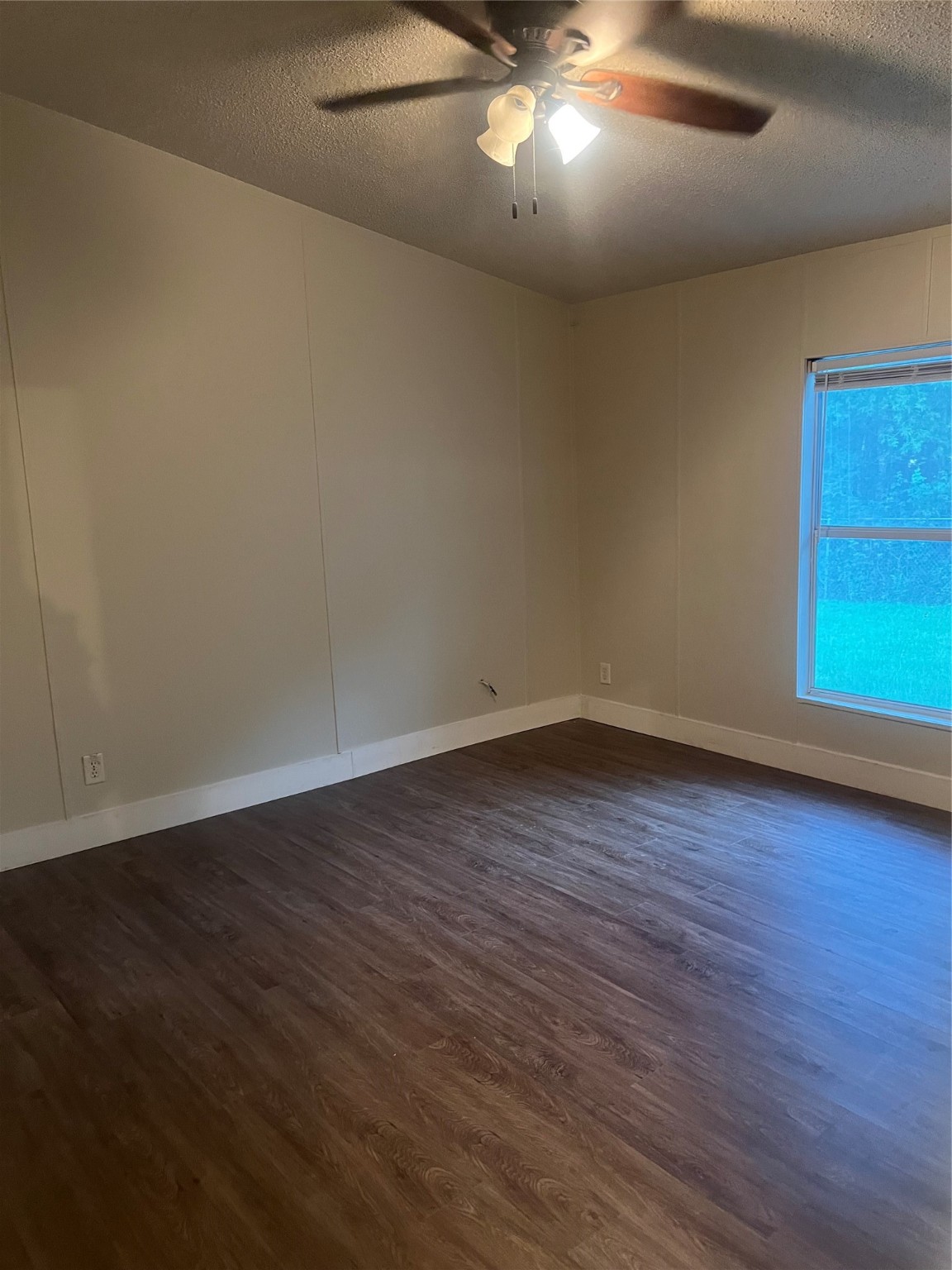 10312 Farm To Market Road 457 Bay City, TX 77414 - Photo 5 of 16 an empty room with wooden floor and windows