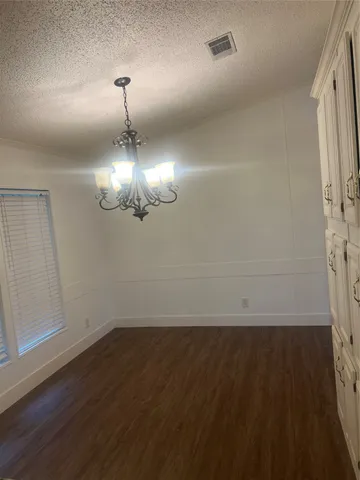 wooden floor in an empty room with a mirror