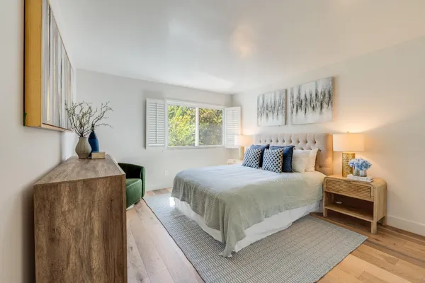 a bedroom with bed and window