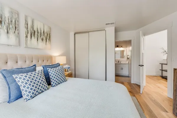 a bedroom with bed and walk in closet