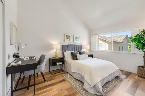 a bedroom with a bed and a table