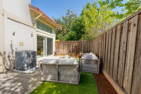a backyard of a house with table and chairs