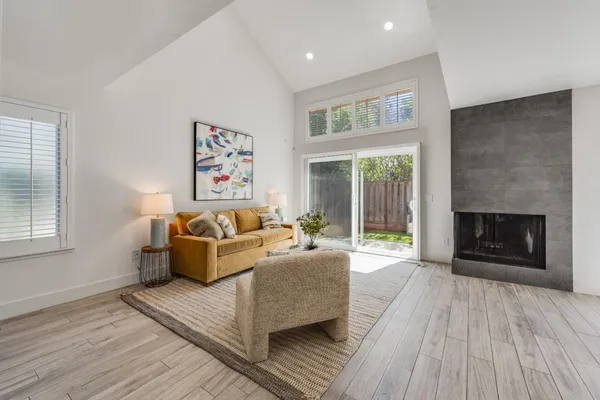 a living room with furniture and a fireplace