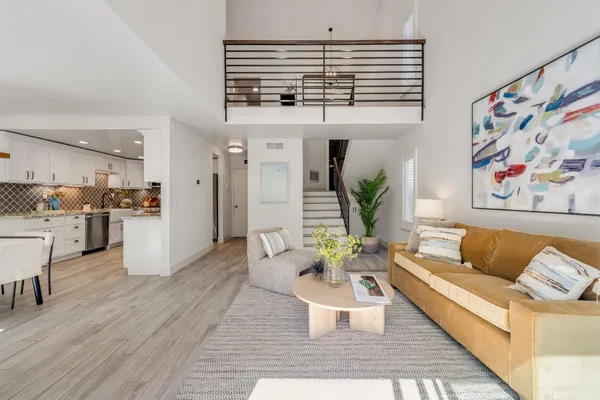 a living room with furniture and kitchen view