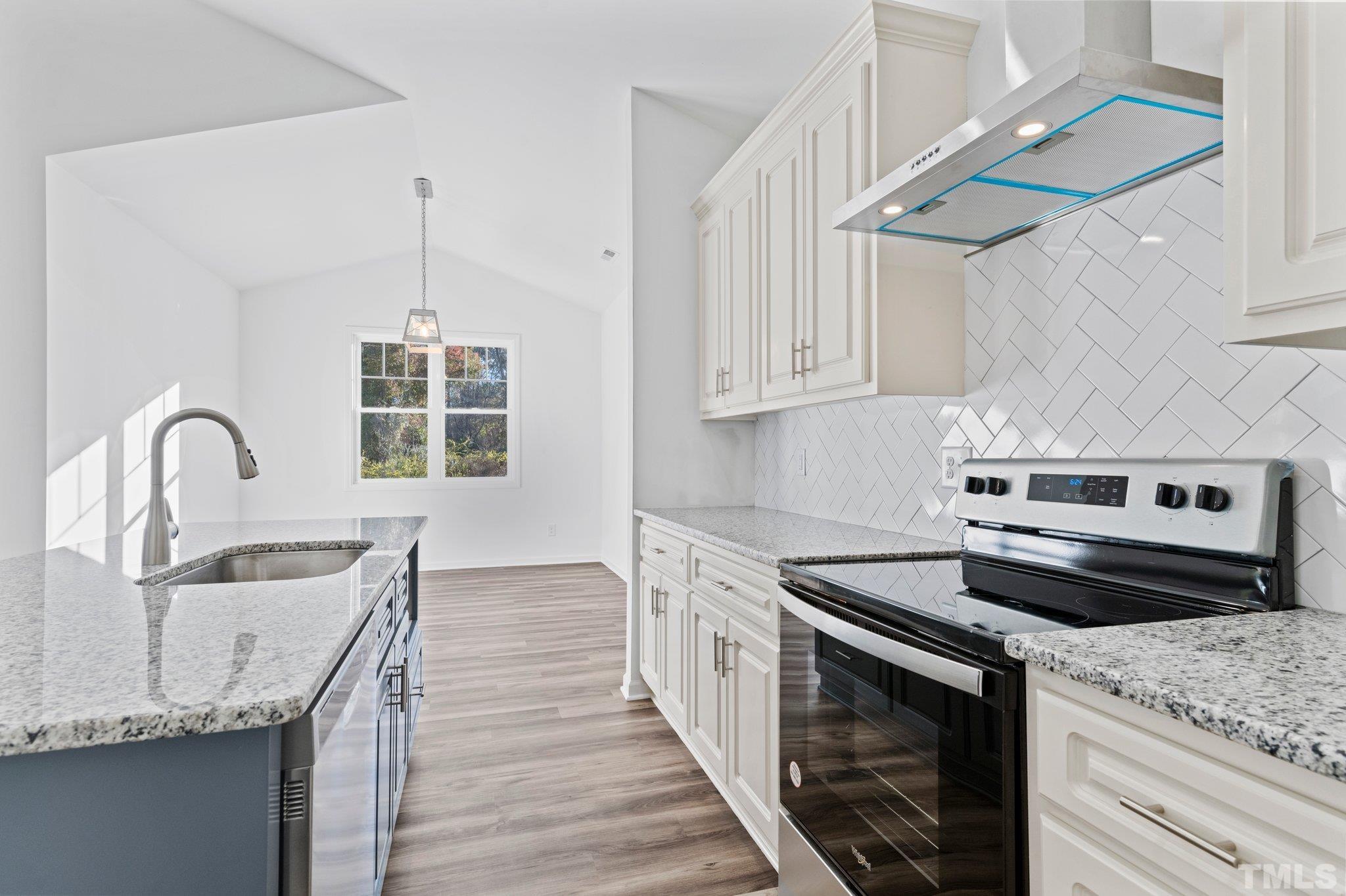 9771 Chapman Road Bailey, NC 27807 - Photo 12 of 35 a kitchen with granite countertop a sink cabinets and stainless steel appliances