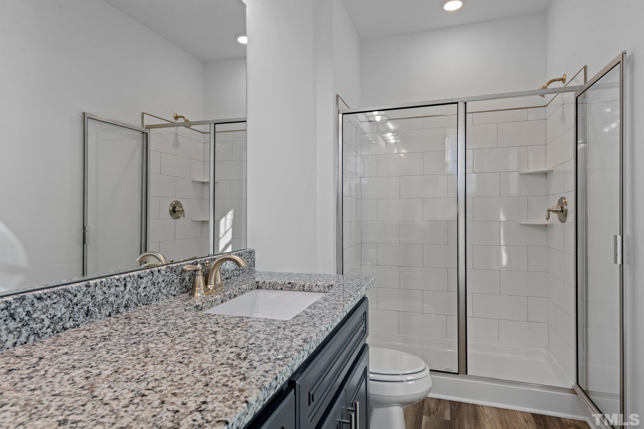 9771 Chapman Road Bailey, NC 27807 - Photo 14 of 35 a bathroom with a granite countertop sink toilet and shower