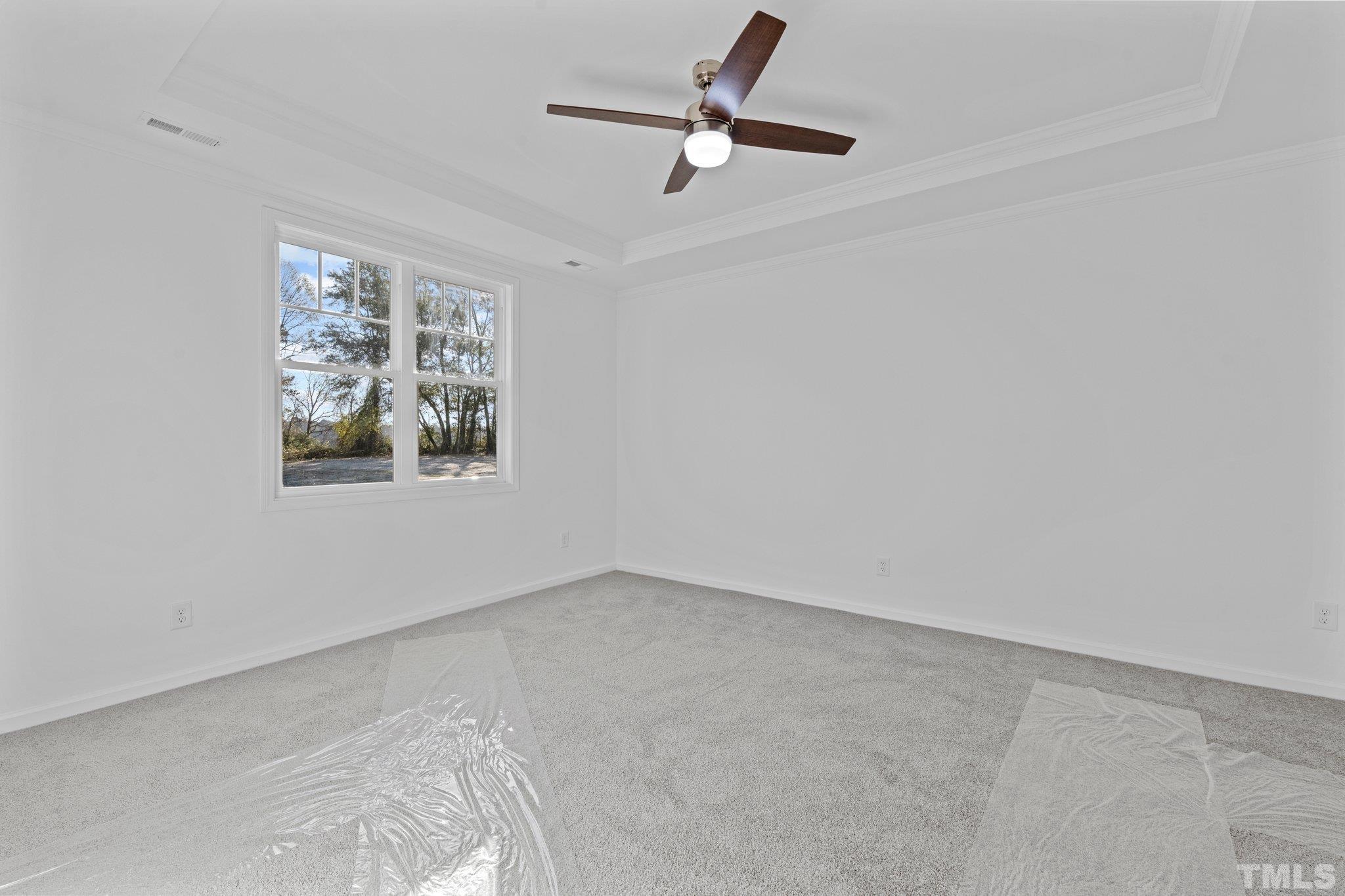 9771 Chapman Road Bailey, NC 27807 - Photo 18 of 35 an empty room with a window and a fan