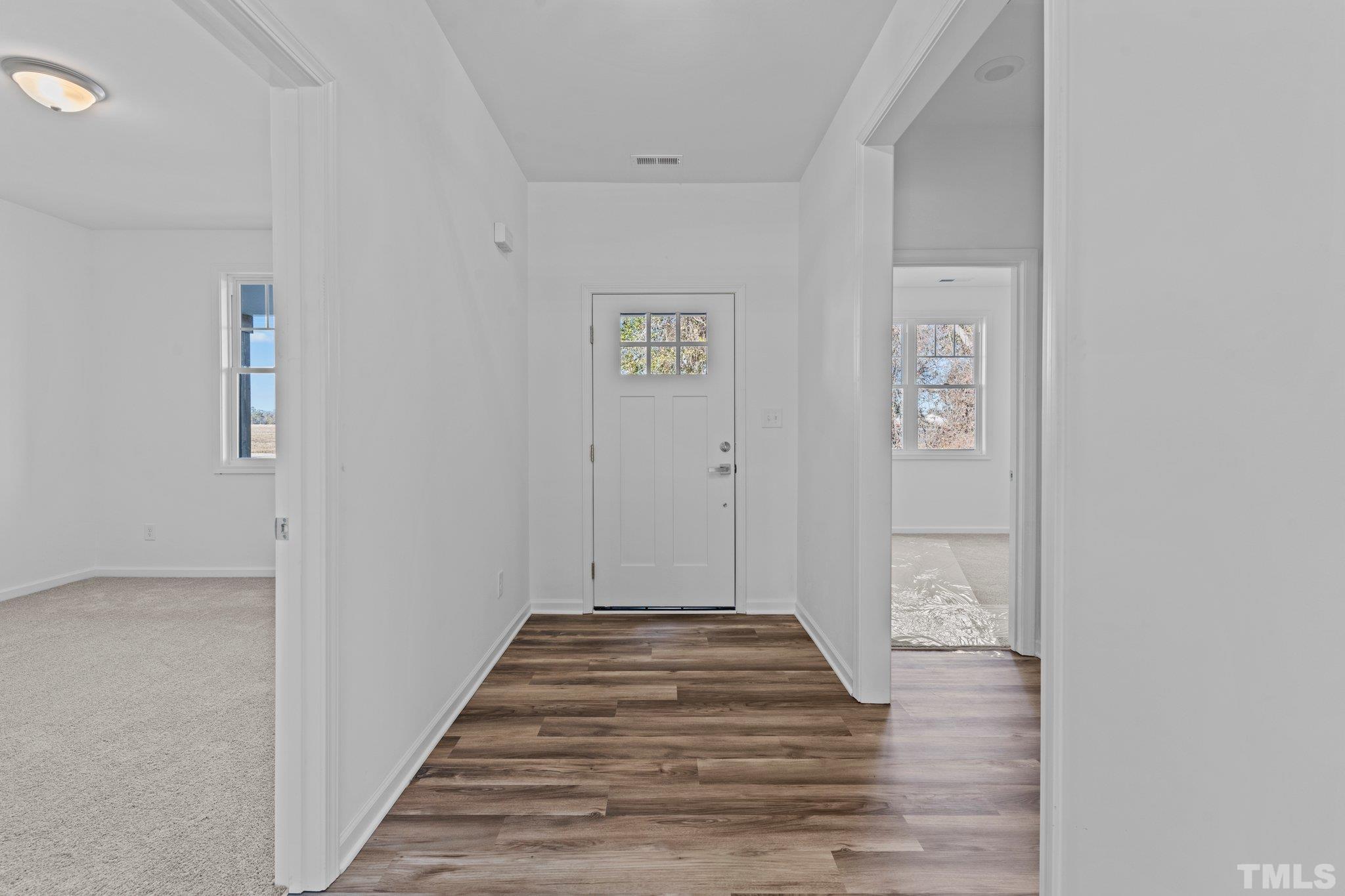 9771 Chapman Road Bailey, NC 27807 - Photo 5 of 35 a view of a hallway with wooden floor