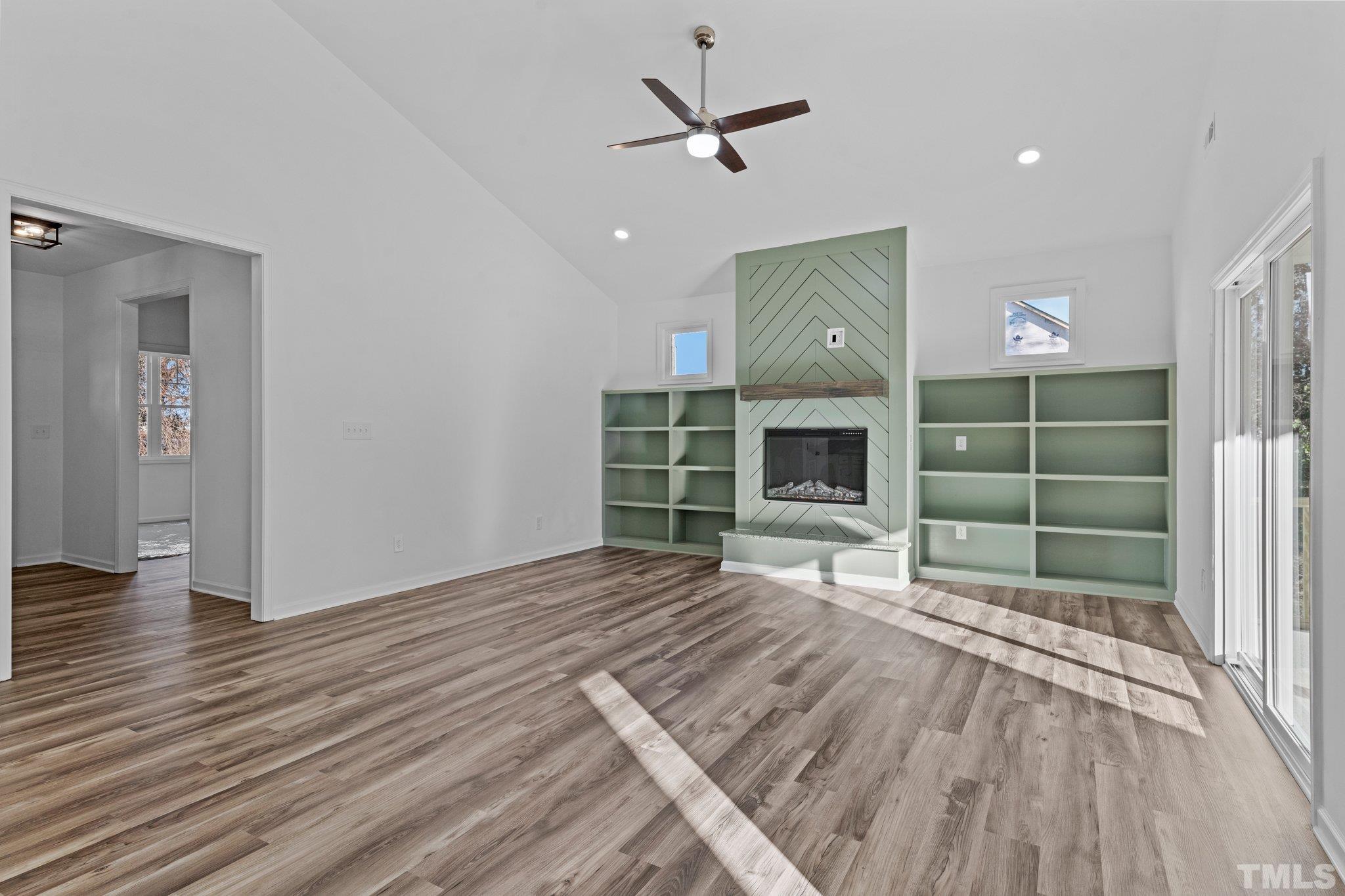 9771 Chapman Road Bailey, NC 27807 - Photo 6 of 35 a view of a livingroom with wooden floor a ceiling fan and a window