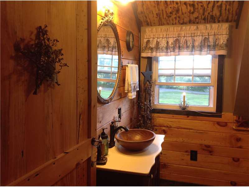 352 Wise Road Jamestown, PA 16134 - Photo 23 of 25 Master Bath/Spa. Knotty pine wood added to walls. Sliding handmade custom barn wood doors. New plumbing. Antique vanity with bronze fixtures.