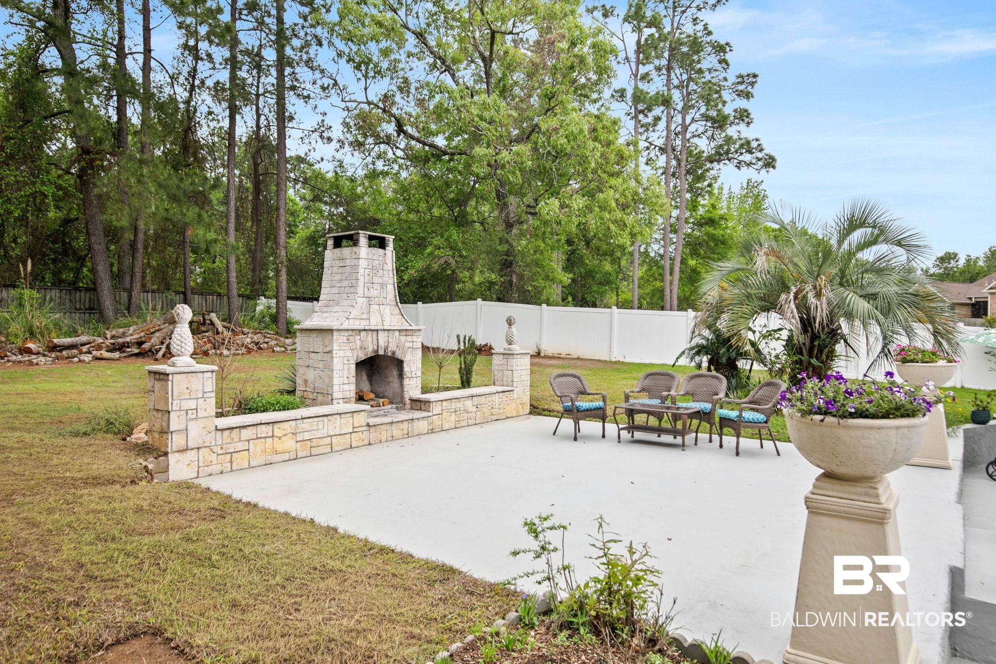 2 Speckle Trout Route Daphne, AL 36527 - Photo 51 of 61 Fenced backyard with an outdoor stone fireplace and a patio