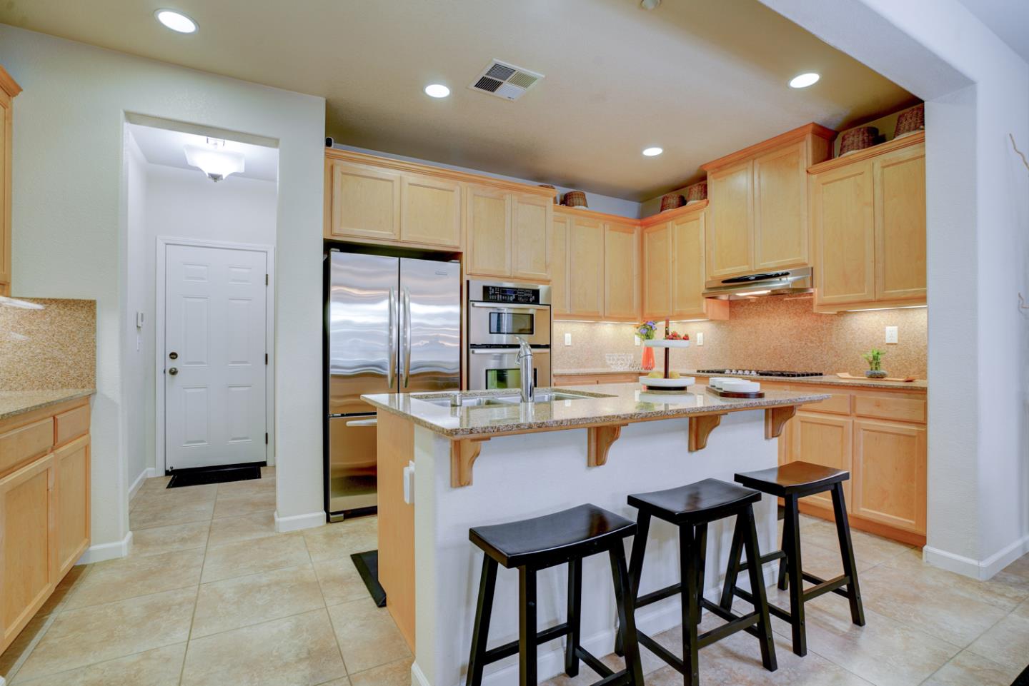 5236 Fioli Loop San Ramon, CA 94582 - Photo 11 of 40 a kitchen with a table chairs refrigerator and cabinets