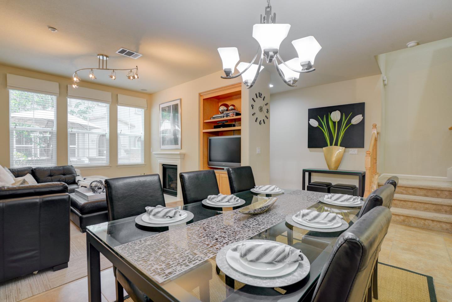5236 Fioli Loop San Ramon, CA 94582 - Photo 6 of 40 a view of a dining room with furniture a chandelier and large windows