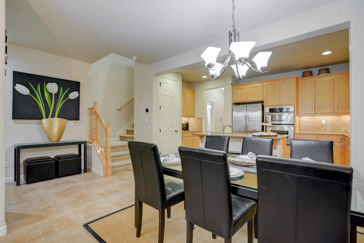 5236 Fioli Loop San Ramon, CA 94582 - Photo 7 of 40 a kitchen with stainless steel appliances granite countertop a dining table chairs and a refrigerator