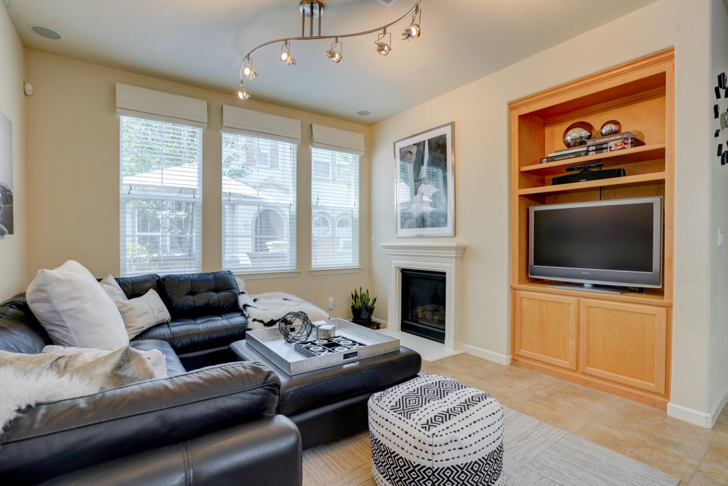 5236 Fioli Loop San Ramon, CA 94582 - Photo 9 of 40 a living room with furniture a fireplace and a flat screen tv