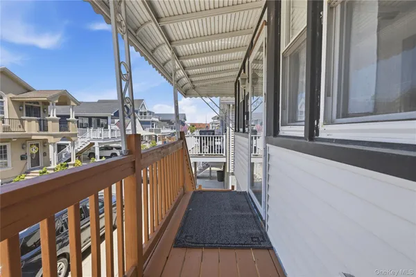 a view of a balcony with wooden floor